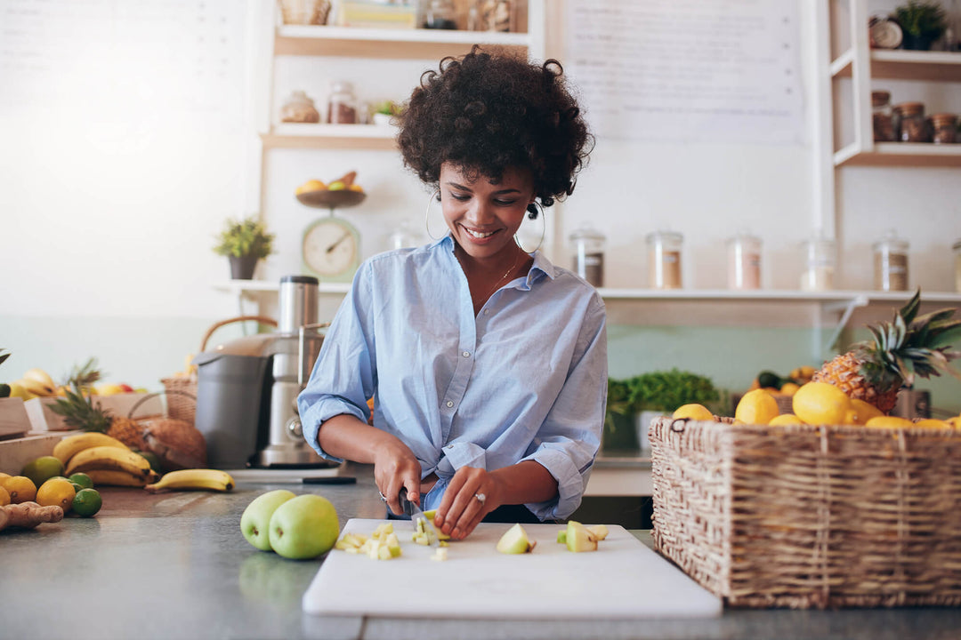 girl slicing up fruits