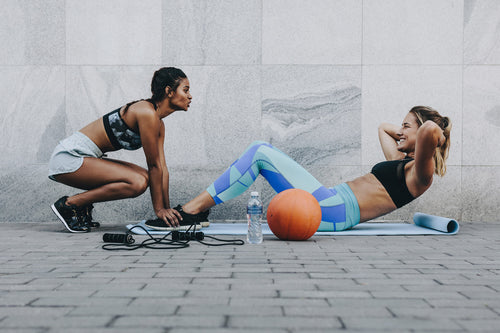 two girls working out together